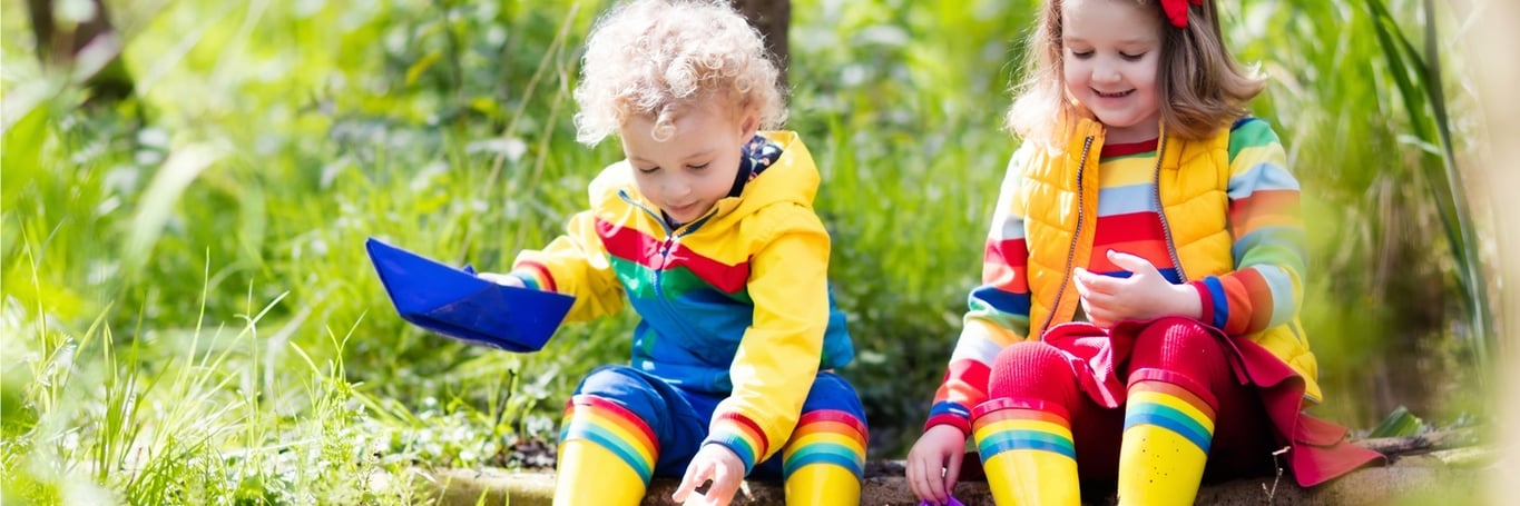 Two children playing in lingering flood waters