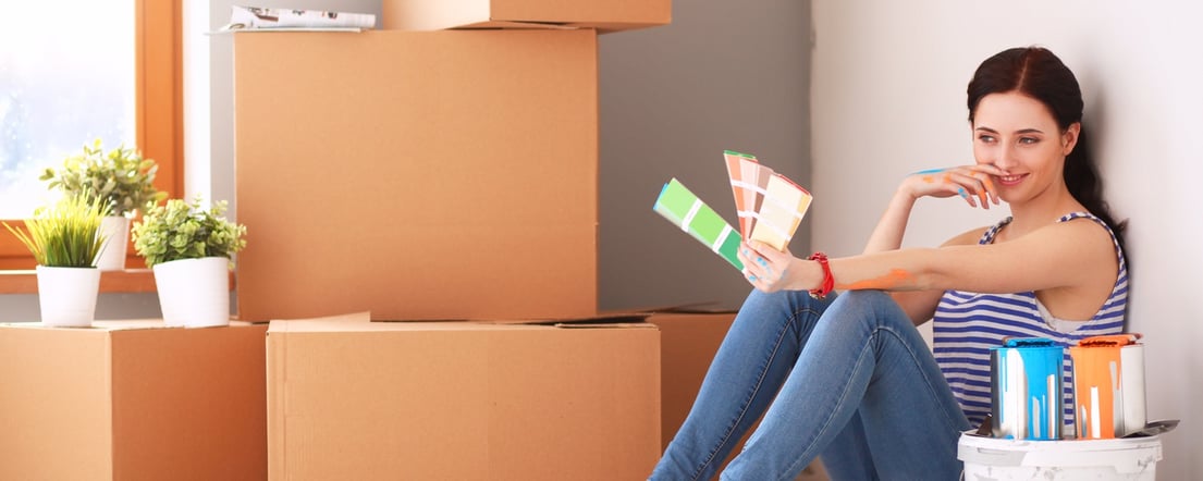 A female homeowner contemplating paint swatches 