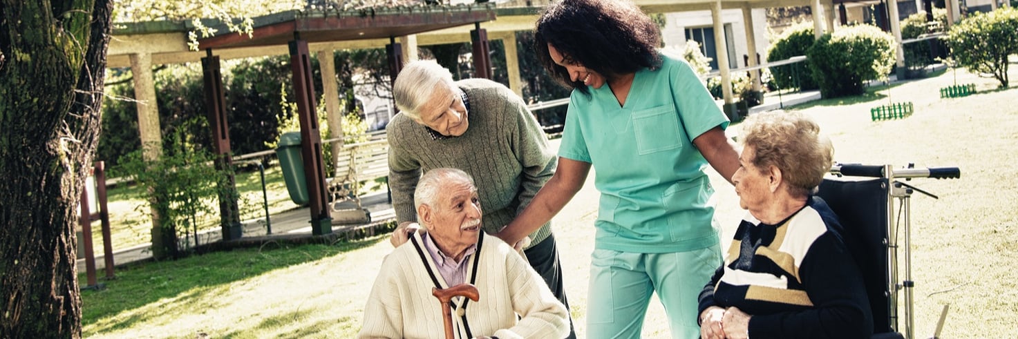 A nurse spending time with nursing home patients that she cares for