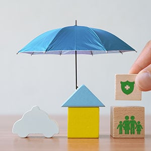 An umbrella covering wooden blocks in various shapes