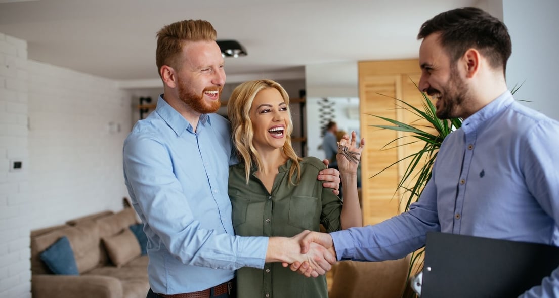 A husband and wife in their home with their independent insurance agent